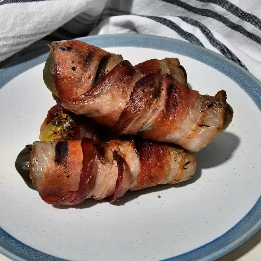 Plated smoked bacon wrapped pickles