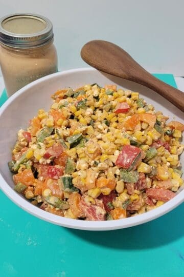 Bowl of grilled corn and peppers salad with chipotle dressing