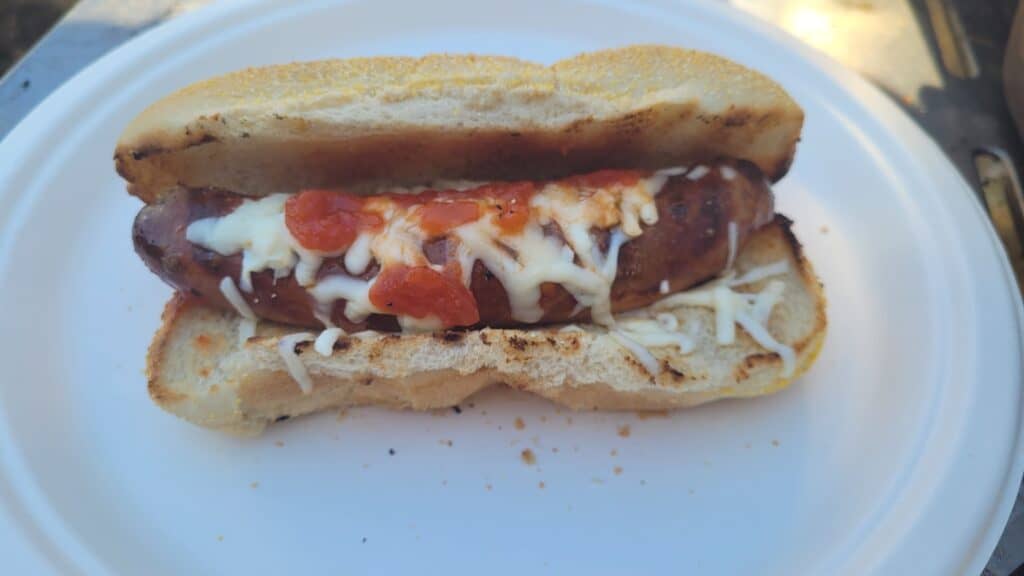 Sausage on a Bun with tomato and cheese