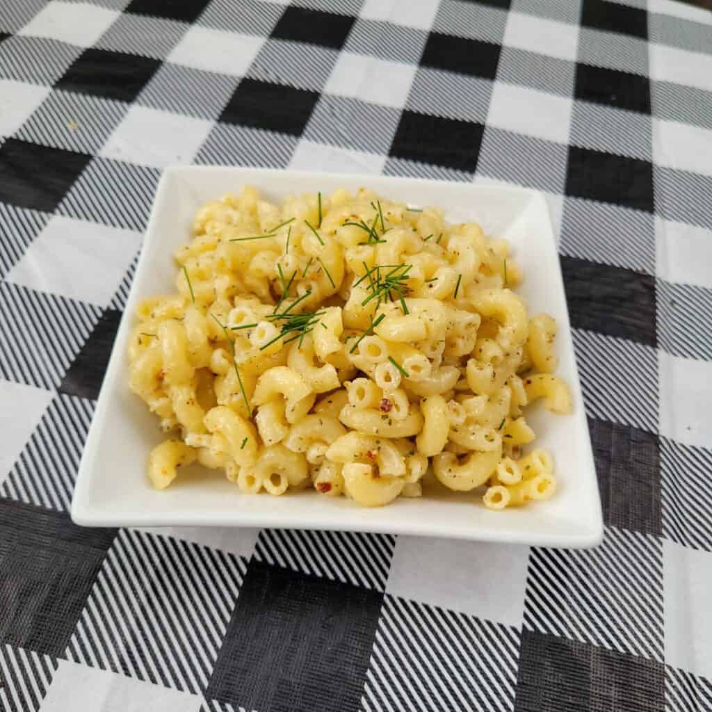 Plated macaroni salad topped with chives
