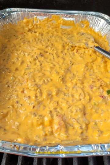 pan of bbq beer cheese queso on the BBQ