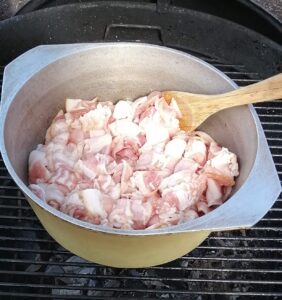 chopped bacon in a heavy bottomed pot over the BBQ