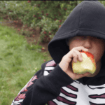 eating an apple while apple picking