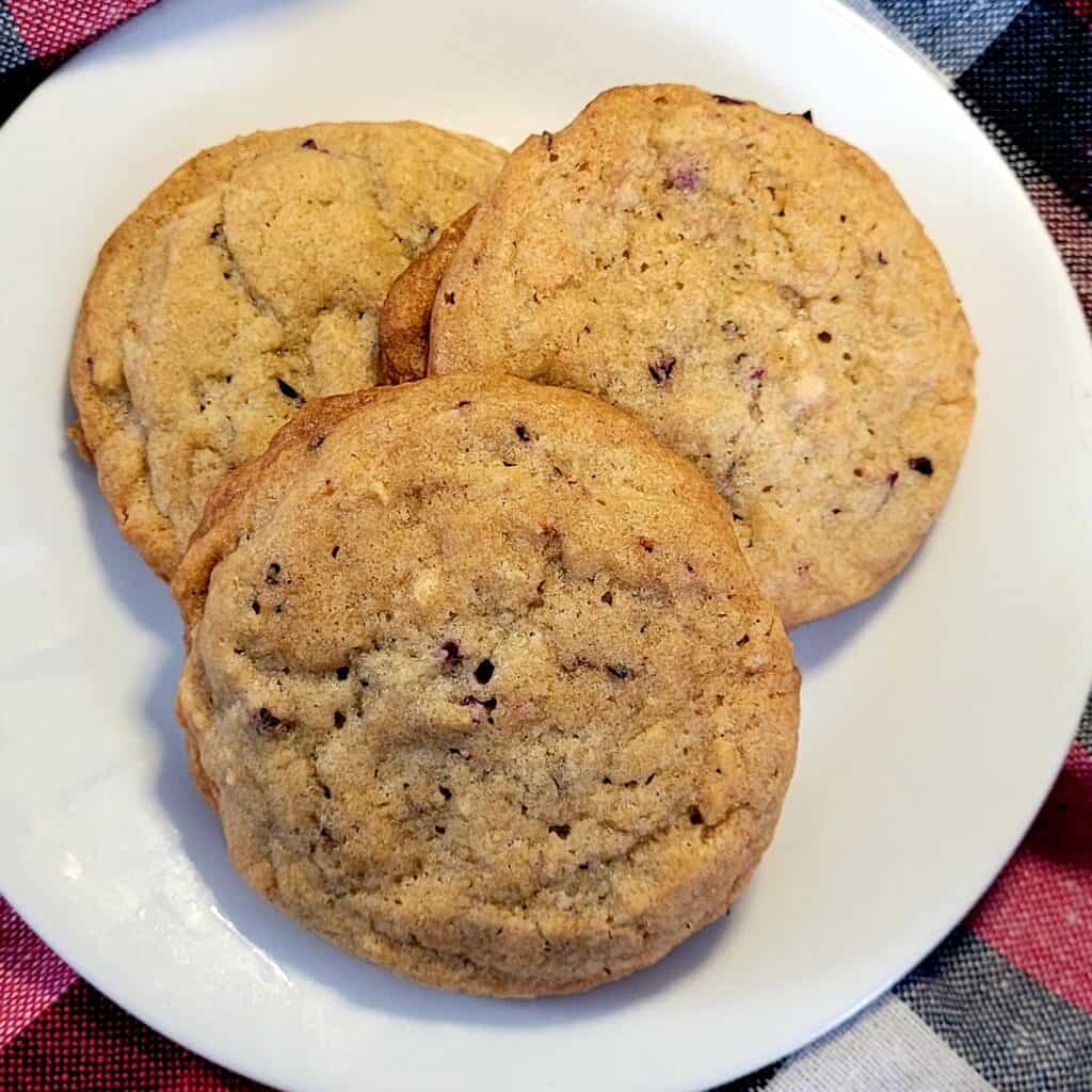 three cranberry cookies on a plate