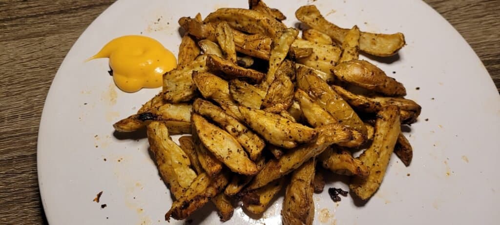 plate of air fryer fingerling potatoes with a side of dip