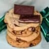 four stacked Andes mint chocolate chip cookies with two Andes mints on top and wrapped Andes mints in background
