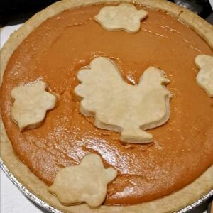 Pumpkin pie with cut outs of crust shaped ike a turkey and leaves