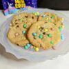 Mini egg cookies on a plate with a bag of Micro Mini Eggs in the background