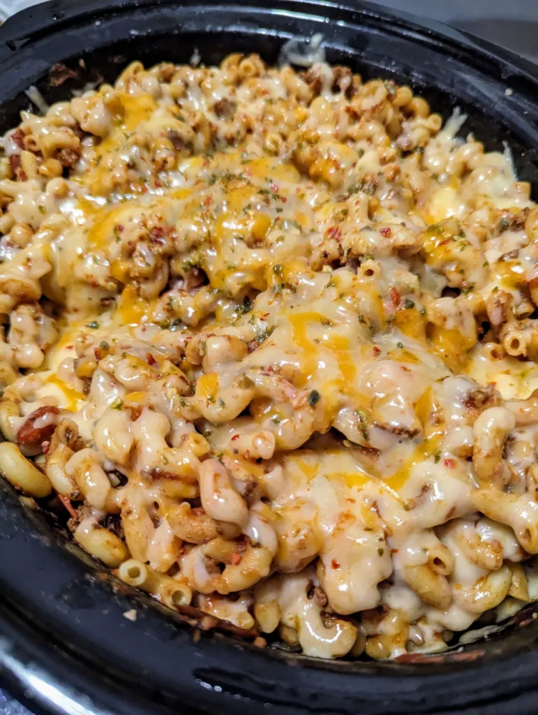 slow cooker chili mac with melted cheese on the top.