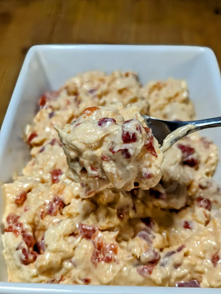 a spoonful of pimento cheese over a bowl of pimento cheese
