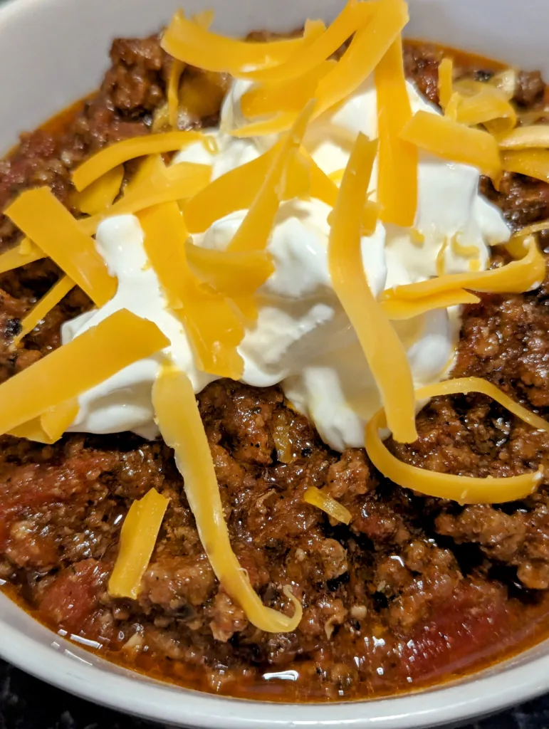 Bowl of chili with cheese and sour cream
